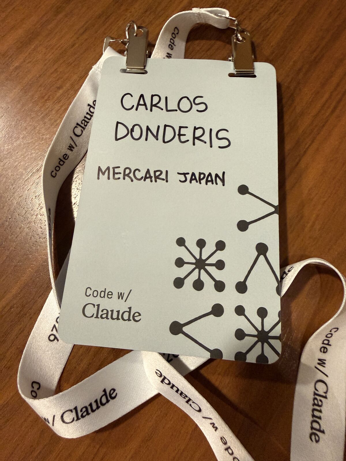 Code w/ Claude Tokyo badge reading Carlos Donderis, Mercari Japan