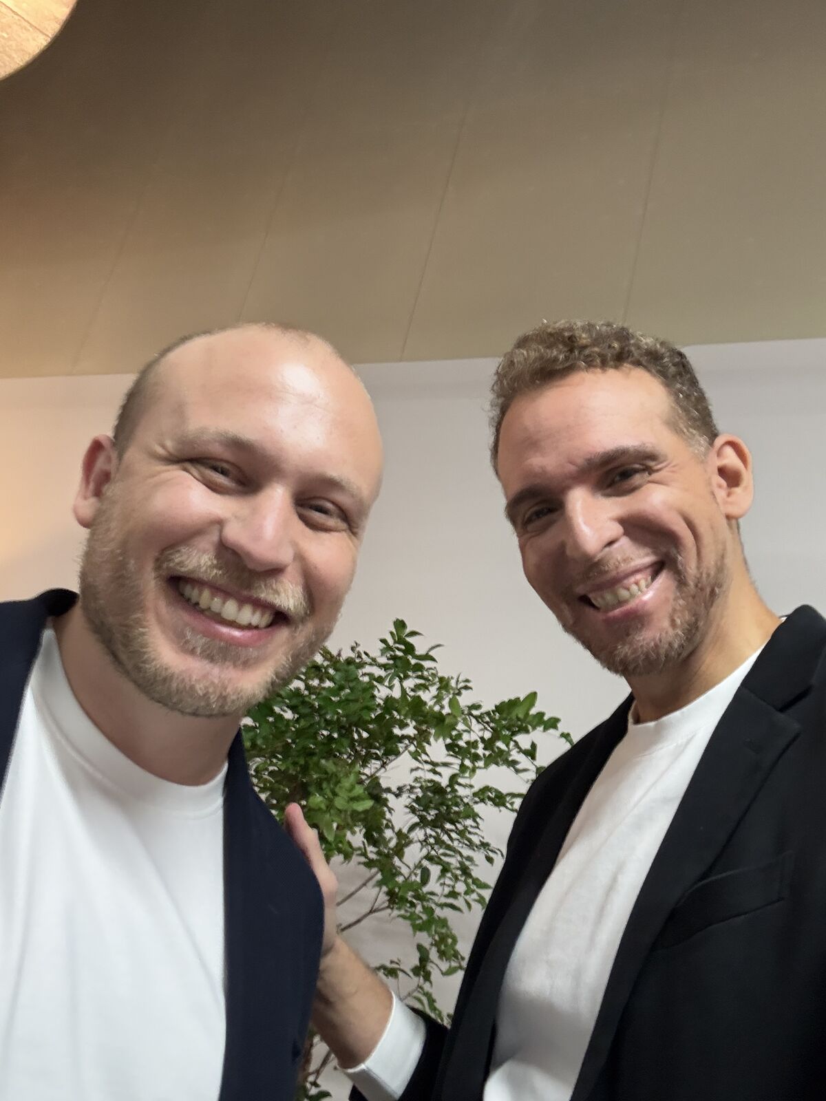 Two people smiling at Code w/ Claude Tokyo